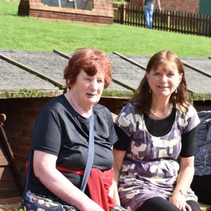 Angela and Heather smiling at the petting zoo