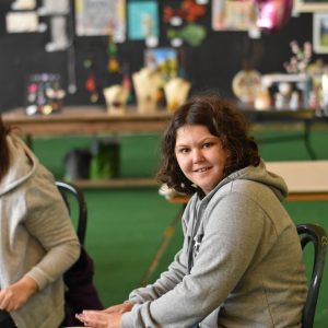Levi smiling whilst playing the drums
